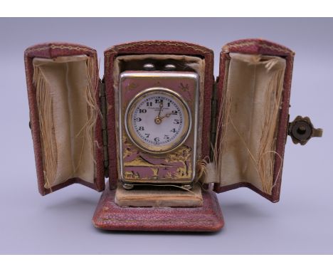 A miniature chinoiserie enamel decorated silver carriage clock in case. 4 cm high.