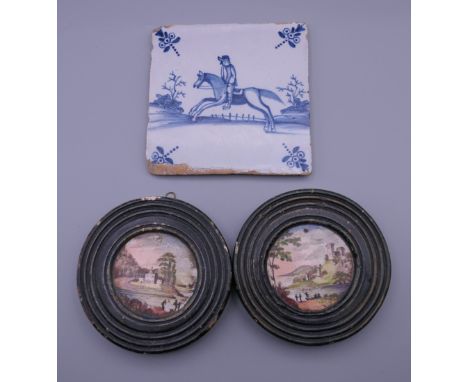 A Delft tile and two 19th century painted plaques. The former 12.5 cm wide.