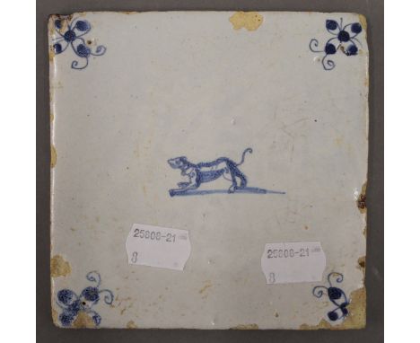 An 18th century Delft tile decorated with a dog. 12.5 cm wide.