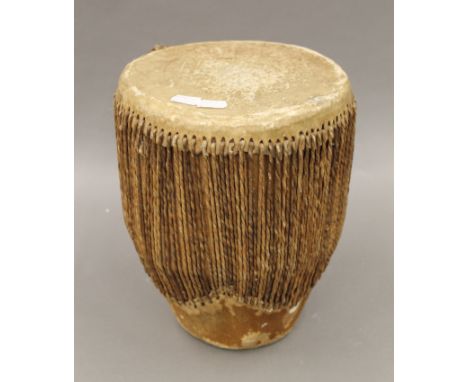 An African hide covered drum. 28 cm high.