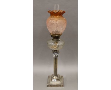A silver plate oil lamp with orange etched shade. 77 cm high overall.