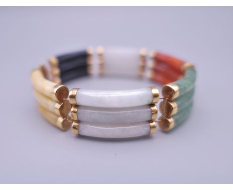 A 14 ct gold multi-colour jade bracelet. 18 cm long.