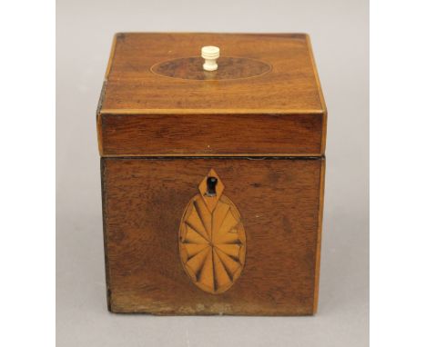 A small cube shaped George III inlaid mahogany tea caddy.  10 cm wide.