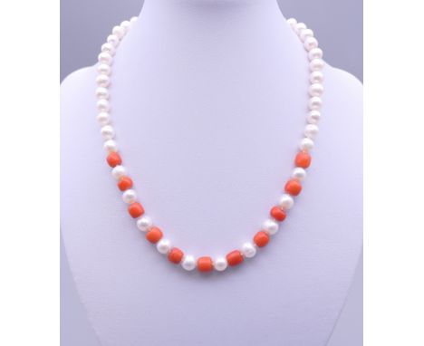 A pearl and coral bead necklace with a 14 ct gold clasp. 40 cm long.