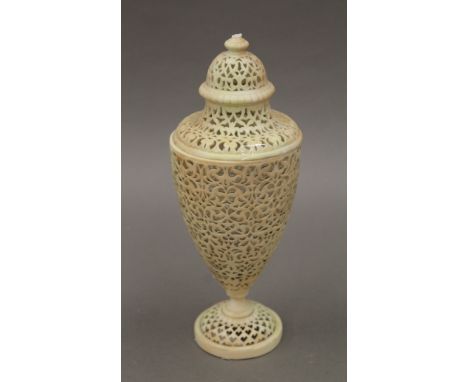 A Royal Worcester blush ivory porcelain reticulated lidded vase. 23 cm high.