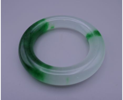A jade bangle. 9 cm exterior diameter and 6 cm interior diameter.
