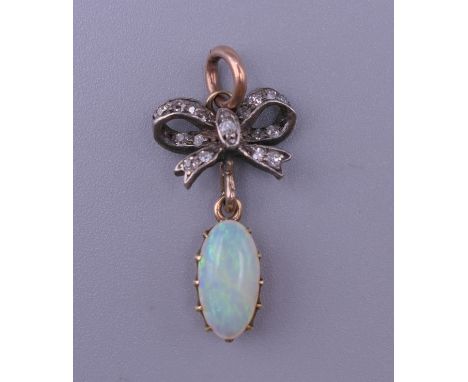 An unmarked gold diamond and opal pendant. 2.5 cm high.