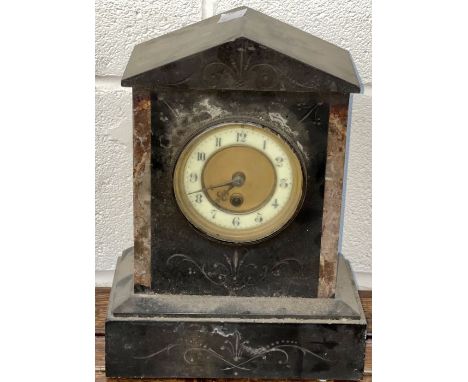 A slate mantel clock with red marble detail