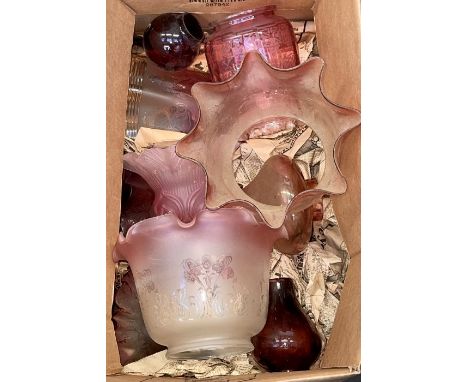 Nine cranberry tint glass oil or gas lamp shades of various designs.