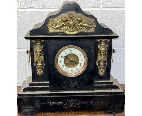 A very large mantel clock with gilded handles and cherub frieze