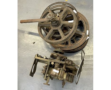 An old film projector, probably early 20th century and 4 film reals.&nbsp;