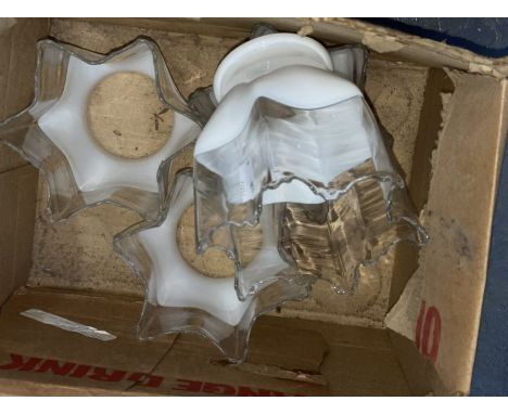 Four white and clear oil or gas lamp shades with handkerchief edges.