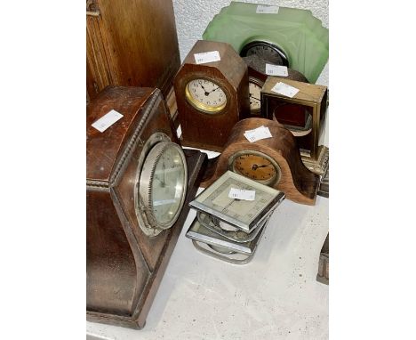 A selection of small wooden clocks as well as two chrome bedside clocks and a uranium glass bedroom clock.