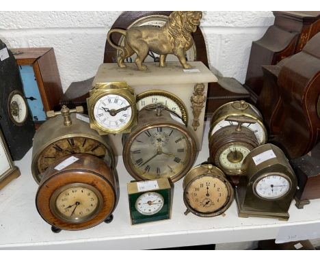 Various clocks, some mantel clocks and some alarm clocks as well as a part soap stone clock case with a metal lion (9)