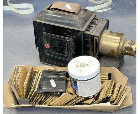 One magic lantern projector and two sets of magic lantern slides one with photographs of an expedition others with colored sl