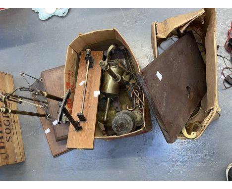 Two boxes containing several sets of brass pillar scales and weights