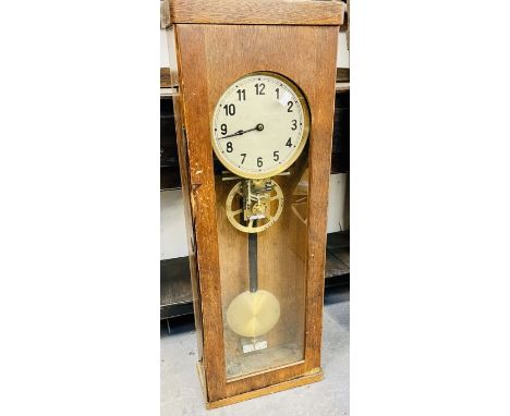 An oak cased electric clock with glass door c1930