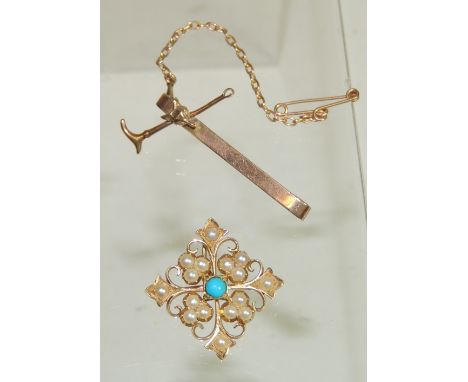 A 9ct gold tie pin with applied fox mask and riding crop decoration and a small unmarked, gold brooch of snowflake form set w