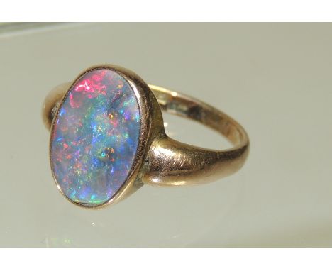 A 9ct Rose gold opal doublet ring, set with oval flat opal.  Ring size L.  