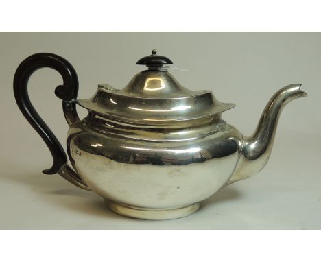 A George V silver teapot of oval form with wood finial and handle, Sheffield 1919, 17.9oz