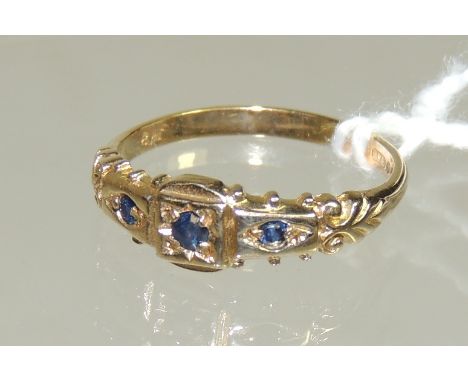 A 9ct gold ladies ring set with three sapphires in a Victorian style mount, ring size K+. 