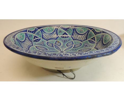 A Turkish Iznik inspired shallow bowl on low pedestal, 37.5cms diam together with a similar footed basin, 41cms diam (2)