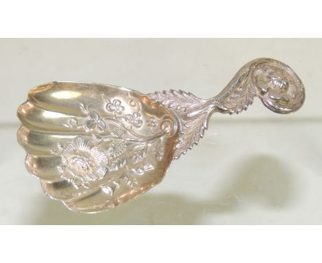 A silver tea caddy spoon, ,the hand shaped bowl with embossed floral decoration and with scroll and floral handle, hallmarked