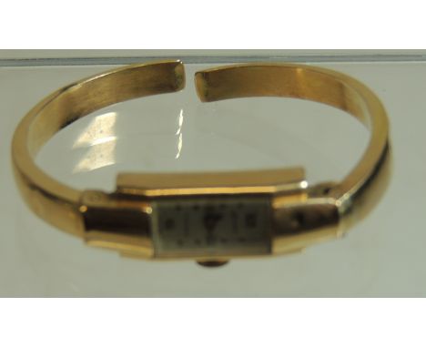 A ladies 18k gold "ONSA" bangle watch.  The hollow hinged bracelet A/F.  Without movement, 7.2g approx.  