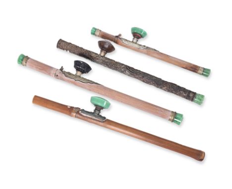 A GROUP OF FOUR CHINESE STYLE OPIUM PIPES
20th Century, mostly in bamboo, imitation jade, pressed white metal, and two with c