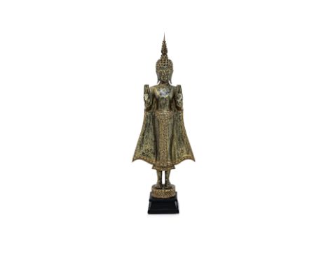 A THAI STANDING BUDDHA STATUE
Gilt and lacquered wood, standing upright, eyes closed and elongated earlobes, hands up and pal