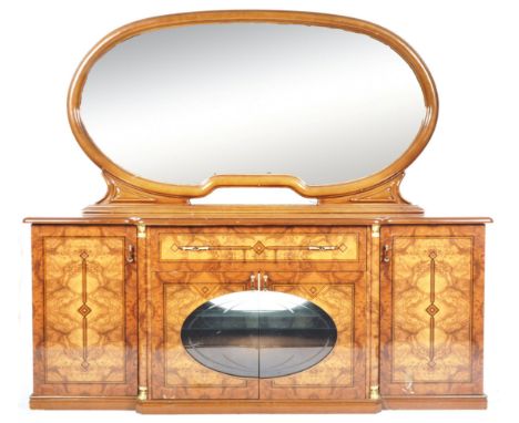 A retro vintage 20th Century Hollywood Regency&nbsp;faux figured walnut mirrored back sideboard credenza having large oval mi