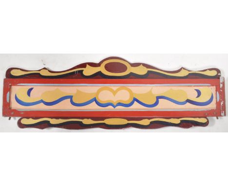 An original mid 20th Century 1950's fairground / funfair hand painted panel finished in red with swirls of yellows, blues and