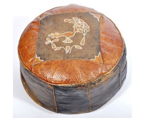 A vintage late 20th Century leather&nbsp;upholstered footstool / pouffe of circular form having a square leather panel top de
