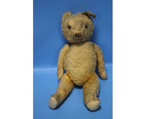 A VINTAGE JOINTED TEDDY BEAR, in play worn condition