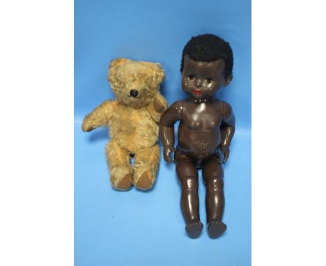 A SMALL VINTAGE JOINTED TEDDY BEAR together with a Pedigree doll