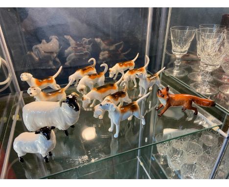 A Shelf of Beswick animals which includes Fox, bugle hunting dogs and sheep. 