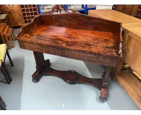 A Victorian mahogany console table/ writing desk. Designed with two under drawers. 