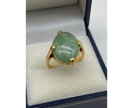 A Lovely example of a hand made 18ct gold [Unmarked] ladies ring set with a large Jade oval stone. Ring size P 1/2. [Weighs 7