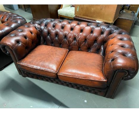 A Three piece Chesterfield suite. Consists of a two seat sofa and two single club chairs. 