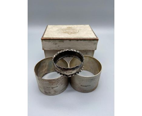 Two Art Deco design Birmingham napkin rings together with one small Birmingham silver napkin ring. 