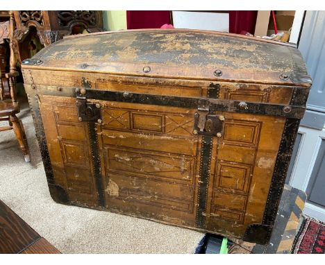 A Large Victorian dome topped travel trunk, Designed with a canvas, wood and metal exterior. Shows a name 'Wassf. Bdicht. Als