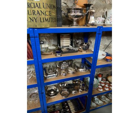 4 Shelves full of silver plated and E.P ware which include large serving tureen and ladle, Ornate coffee pots, Tea services, 
