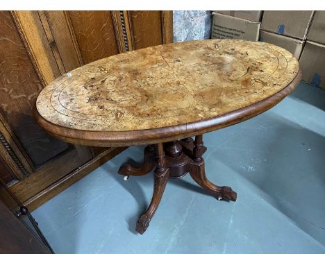 A Victorian bur walnut top console table designed with four pedestal and leg supports. Top showing various inlays. and comes 