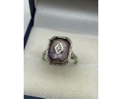 A Lovely example of a ladies 18ct white gold Art Deco ring. Designed with a single Amethyst Cushion cut stone and centred wit