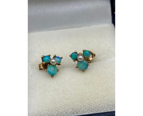 A Pair of antique 9ct gold, Black opal and single pearl earrings. Each earring is designed with three black opals and single 