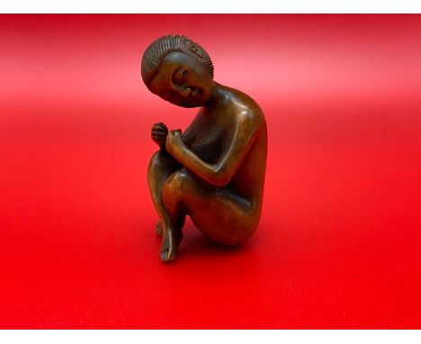 A Japanese hand carved netsuke of a nude geisha figurine. Signed by the artist. 