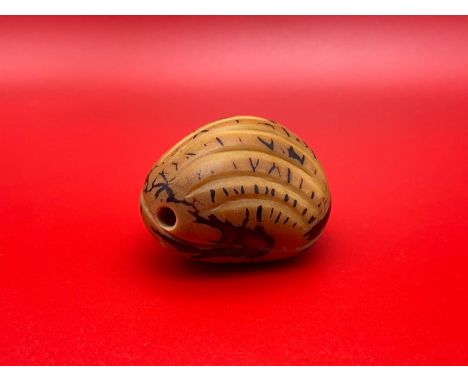 A Japanese hand carved netsuke of an Oyster shell carved from a tagua nut. 