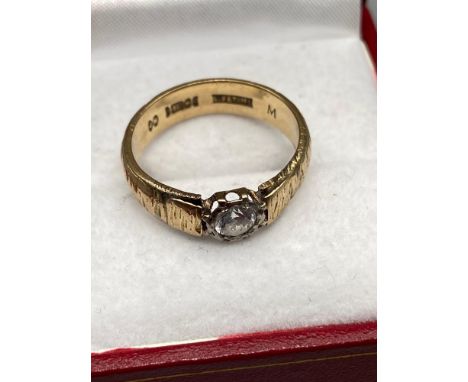 A Gent's 9ct gold ring set with a large clear stone. [Ring size O] [4.28Grams] 