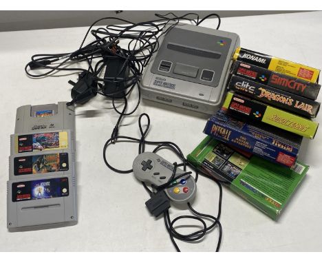 A Super Nintendo games console with assortment of games and controller (untested) 