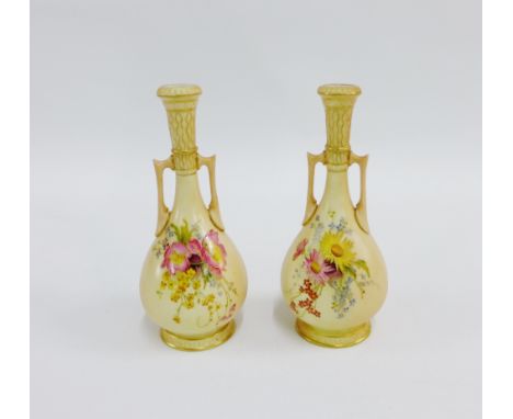 Pair of Royal Worcester blush ivory twin handled vases, painted with floral sprays and printed backstamp and shape No.942, 17